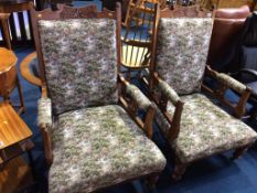 A pair of Edwardian oak armchairs