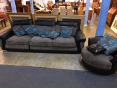 A grey and black leather settee and circular swivel armchair