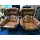 A pair of button back brown office swivel chairs