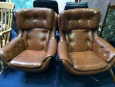 A pair of button back brown office swivel chairs