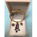 A 9ct gold bangle, mounted with amethysts and seed pearls, 12g and a pair of similar earrings and