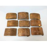 A collection of nine brass belt buckles