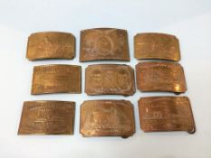 A collection of nine brass belt buckles