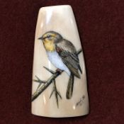 Scrimshaw; Portraits of a bird, carved onto a piece of fossil walrus ivory, by Frank Barcelos