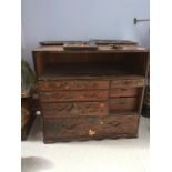 A late 19th century Japanese small chest of drawers with sliding doors, the whole applied with