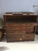 A late 19th century Japanese small chest of drawers with sliding doors, the whole applied with