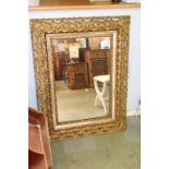 An ornate gilt mirror, 82cm x 109cm