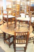 An oak gateleg table with eight dining chairs