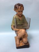 A 1930s plaster model of a kneeling boy holding a glass fish bowl. 52cm high