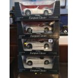 Four boxed ERTL cars