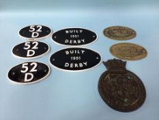 A collection of name plates and railway plaques