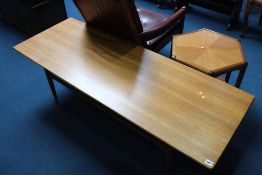 A long G Plan coffee table, an octagonal occasional table and a teak framed armchair