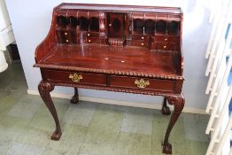A reproduction mahogany desk