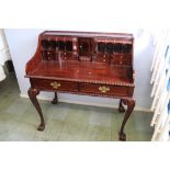 A reproduction mahogany desk