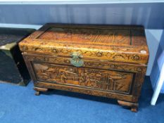 A carved Oriental camphorwood chest