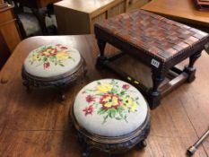 A pair of embroidered circular footstools and an oak and leather stool