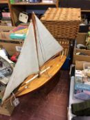 Three picnic hampers and a pond yacht