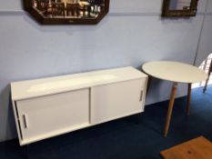 A modern circular table and a modern white sideboard