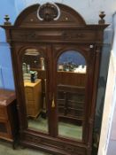 An early 20th century French two mirror door armoire