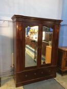 An Edwardian mahogany two mirror door wardrobe, with two drawers