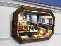An oak framed bevelled mirror