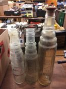 Three glass oil bottles and a can