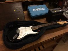 A Fender Squire Strat 20th Anniversary guitar and an amp