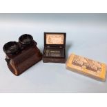 A music box and a burr walnut stereo viewer, with cards