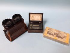 A music box and a burr walnut stereo viewer, with cards