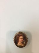 A miniature portrait, mounted in a 9ct gold brooch, 15g total