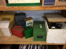 A shelf of assorted, to include petrol and oil cans