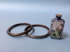 An Oriental scent bottle and two Oriental bamboo bracelets, mounted with white metal