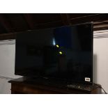 A Panasonic TV, with remote