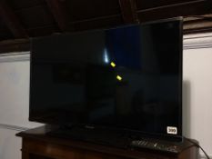 A Panasonic TV, with remote