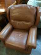 A pair of tan leather armchairs