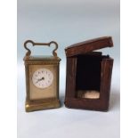 A carriage clock and fitted travelling case