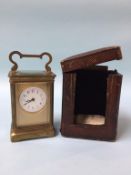 A carriage clock and fitted travelling case