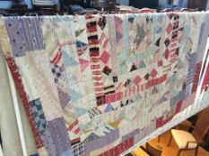 A double Durham patchwork quilt with tassels and cream reverse