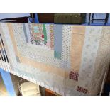 A double Durham patchwork quilt, with cream reverse