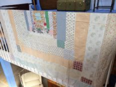 A double Durham patchwork quilt, with cream reverse