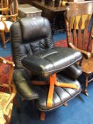 A black leather swivel chair and footstool