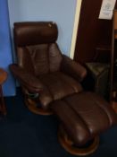 A brown leather reclining chair and footstool