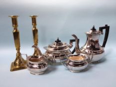 A pair of brass candlesticks and a silver plated tea service