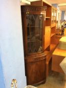 A reproduction mahogany corner cabinet