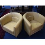 A pair of Ikea yellow tub chairs