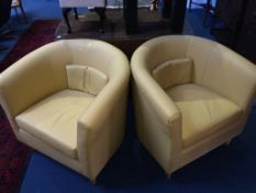 A pair of Ikea yellow tub chairs