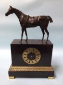 A late 19th century slate clock, surmounted by a bronze horse, the movement by Raingo of Paris, 8