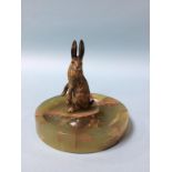 A cold painted bronze Hare, mounted on an onyx ashtray