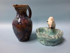 A stoneware jug and a Continental pottery polar bear looking in his pond