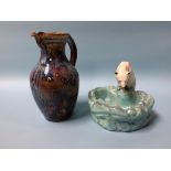 A stoneware jug and a Continental pottery polar bear looking in his pond